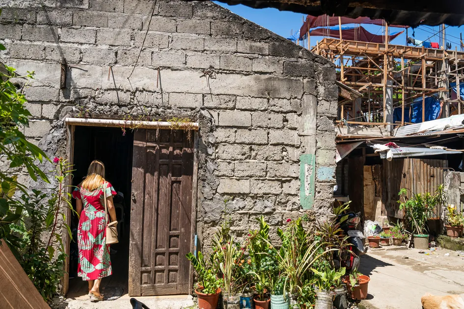 A woman enters a humble church building situated in the slums of Cagayan de Oro.